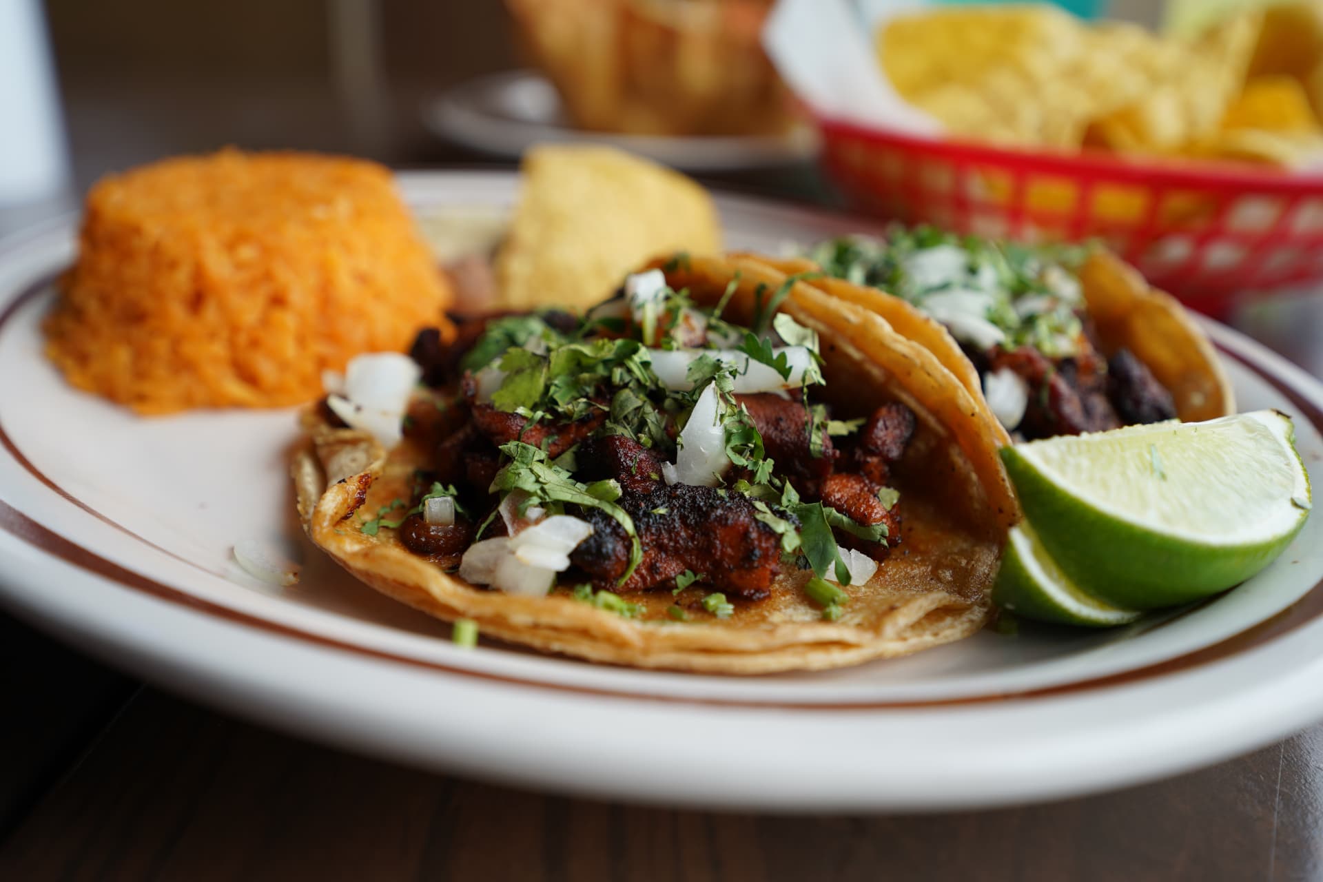 Carne asada tacos with rice, lime, onion, and cilantro