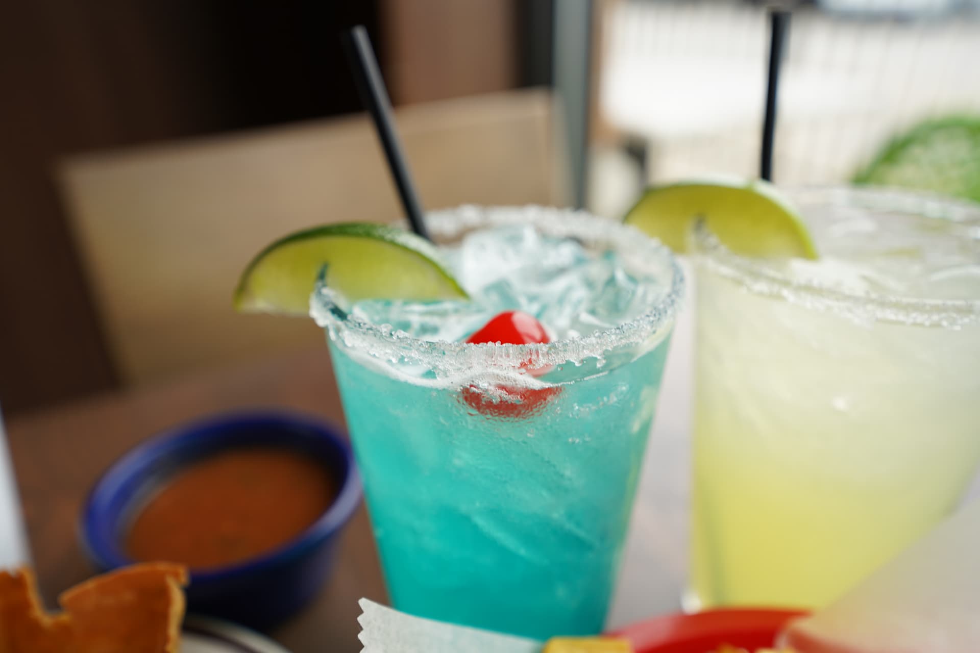Blue and lime margaritas garnished with fresh lime
